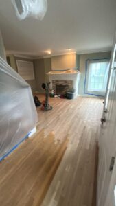 Living room hardwood floor during sanding & finishing process in Milford, CT.