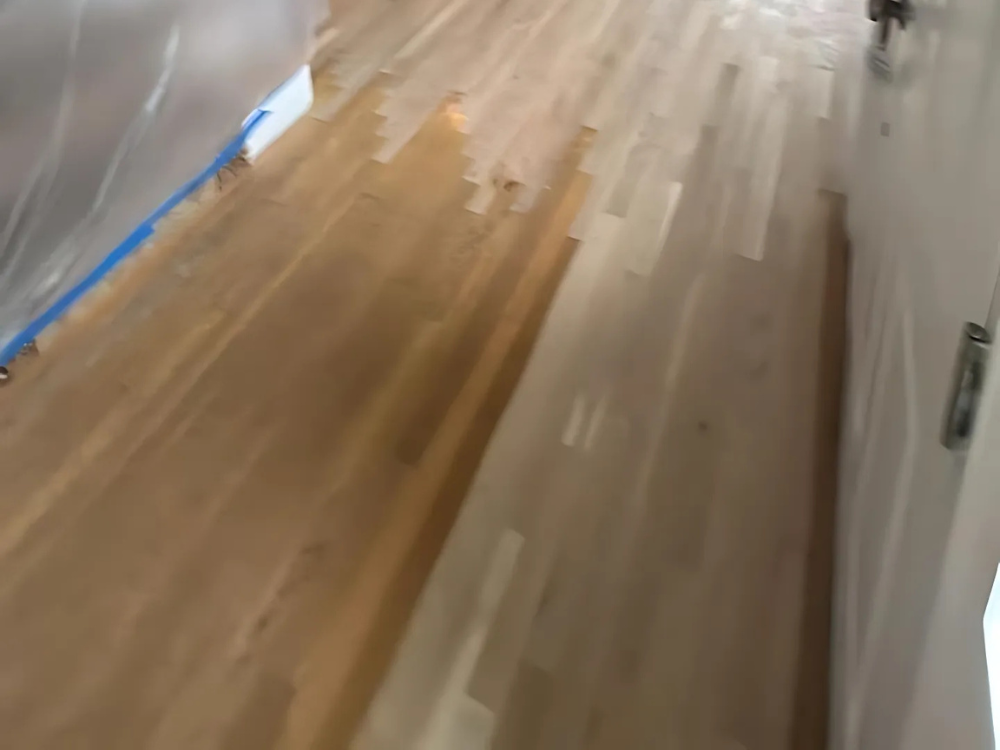Living room hardwood floor during sanding & finishing process in Milford, CT.