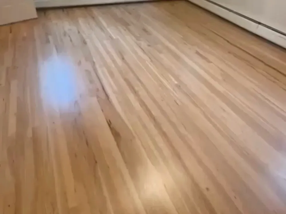 Refinished wood floors in a two-story house in Wethersfield, showcasing a smooth, polished finish after restoration