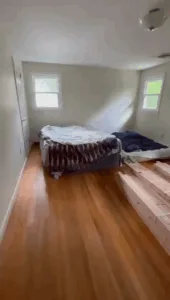 Restored wood flooring in a two-story Wethersfield home, showing a clean, smooth surface after refinishing.