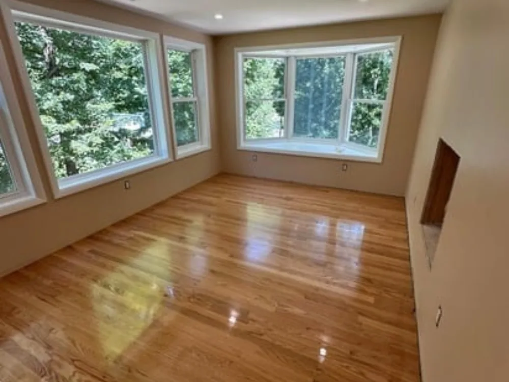 Room with large windows and refinished hardwood floors – Hardwood Floor Repairs and Refinishing in South Windsor CT