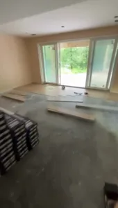 Floor installation in South Windsor CT with planks being arranged over the subfloor in a living space under construction.