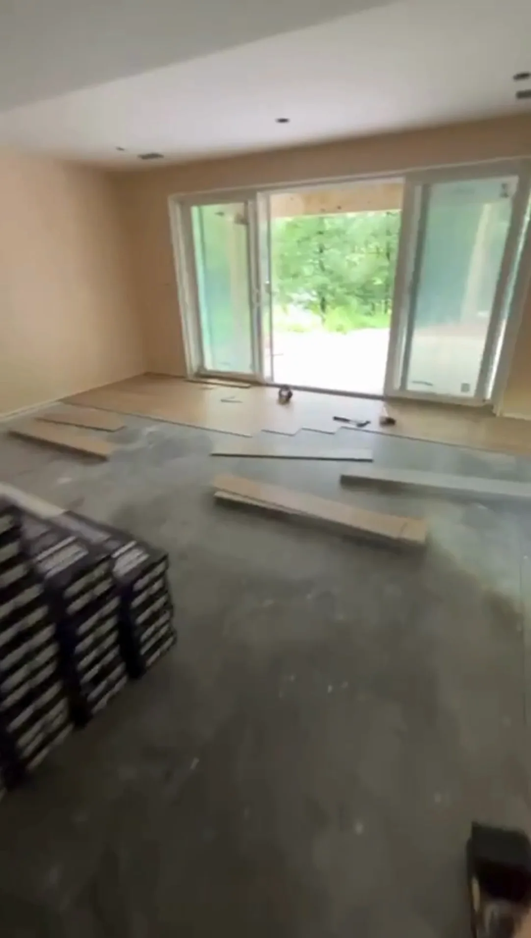 Floor installation in South Windsor CT with planks being arranged over the subfloor in a living space under construction.