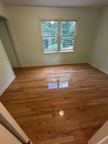 Light green room displaying the smooth results of a Cheshire hardwood floor installation.